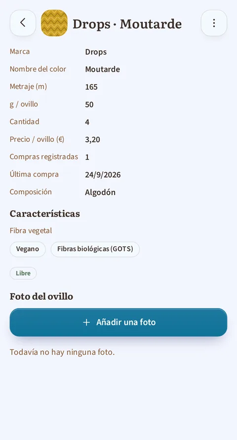 La ficha a pantalla completa de Drops · Moutarde: marca Drops, 165 m, 50 g por ovillo, cantidad 4 a 3,20 €, una compra registrada, la última el 24/9/2026, composición Algodón, luego Fibra vegetal, las etiquetas Vegano y Fibras biológicas (GOTS), el estado Libre y el botón Añadir una foto